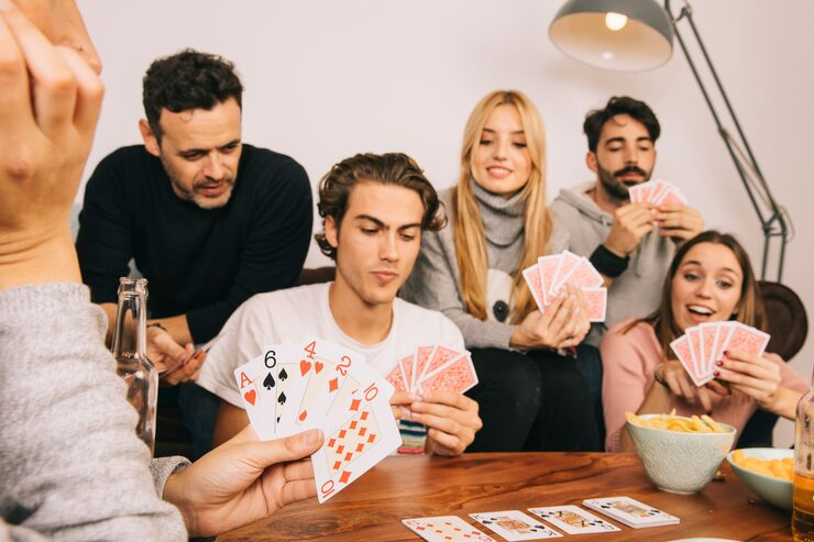 Host explaining cards to guests at an evening event